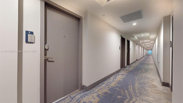 hallway with dark carpet