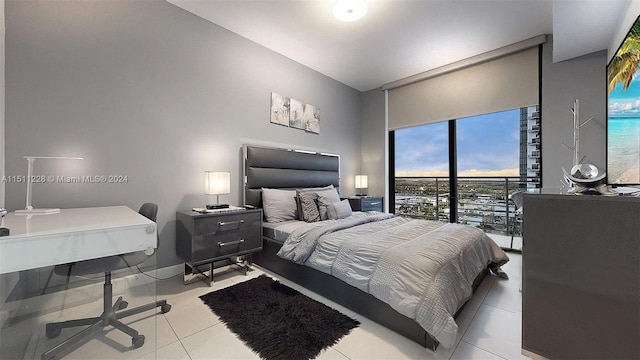 bedroom featuring light tile patterned flooring and access to exterior