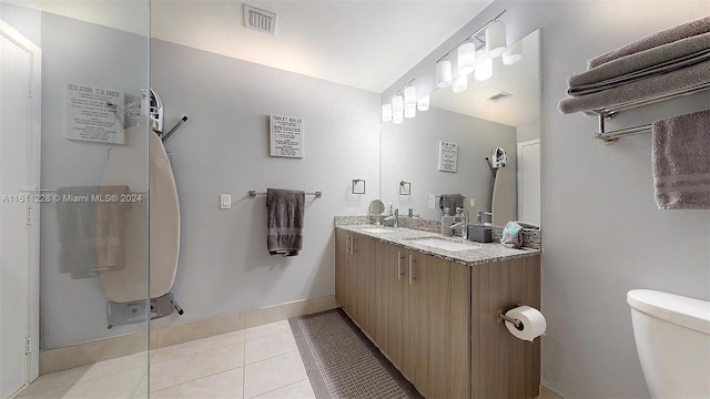 bathroom featuring vanity, toilet, and tile patterned flooring