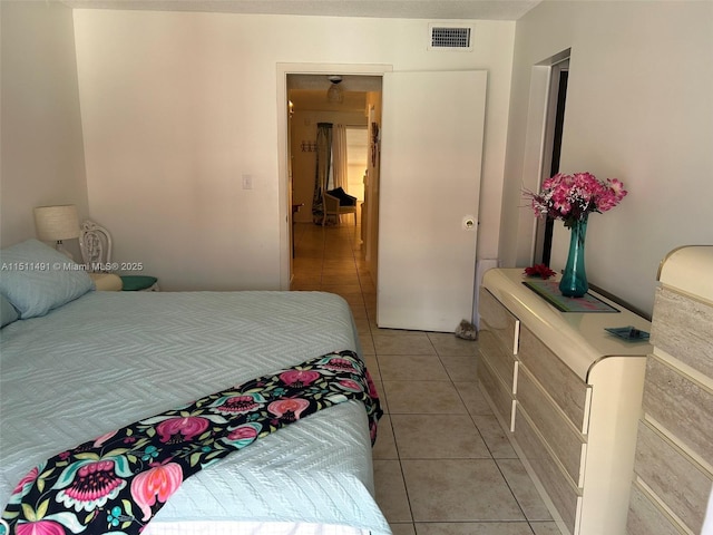 bedroom with light tile patterned floors