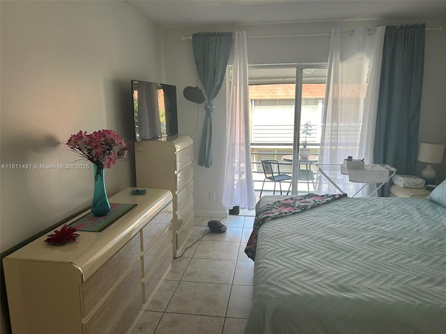 bedroom with light tile patterned floors and access to outside