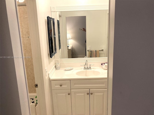 bathroom featuring washtub / shower combination and vanity