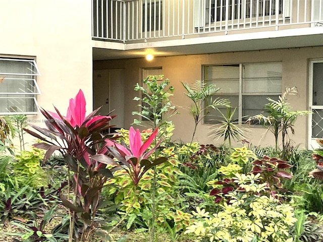 view of exterior entry featuring a balcony