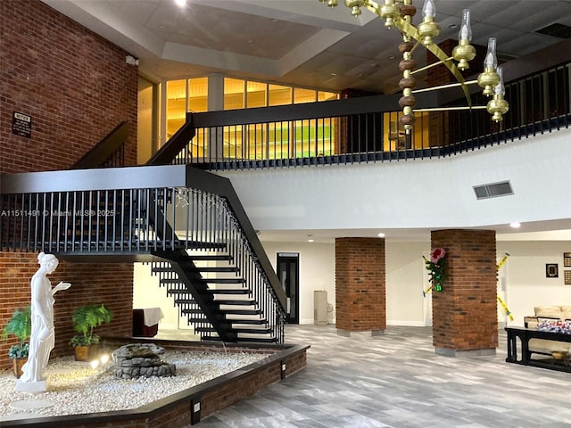 stairway featuring a towering ceiling