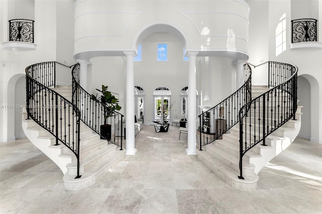 foyer featuring a high ceiling and decorative columns