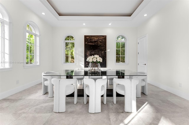 dining area with recessed lighting, baseboards, and a raised ceiling