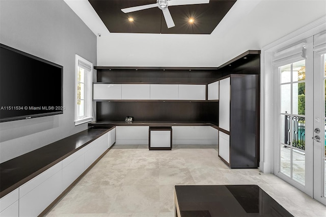 kitchen with white cabinets, fridge, and ceiling fan