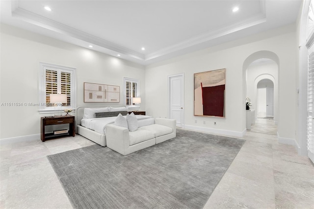 bedroom with a tray ceiling and a towering ceiling