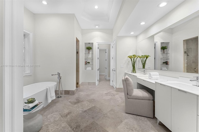 full bathroom with recessed lighting, a freestanding tub, a stall shower, vanity, and baseboards