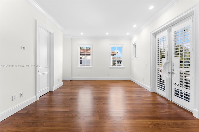 empty room with plenty of natural light, dark wood-type flooring, french doors, and ornamental molding