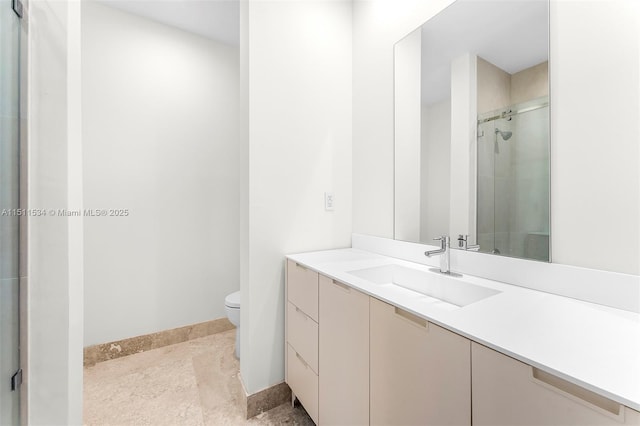 bathroom with vanity, toilet, and a shower with door