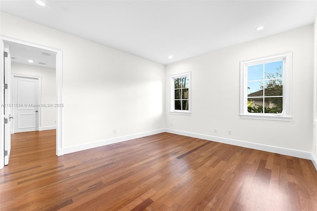 empty room with hardwood / wood-style floors