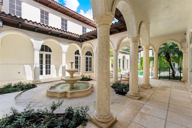view of patio / terrace featuring french doors and fence