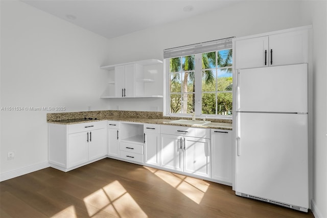 kitchen with white cabinets, white appliances, dark wood-type flooring, and dark stone countertops