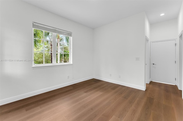 spare room with dark hardwood / wood-style floors