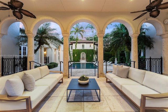 patio terrace at dusk with an outdoor living space and ceiling fan