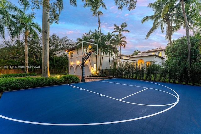 view of sport court featuring basketball court and fence