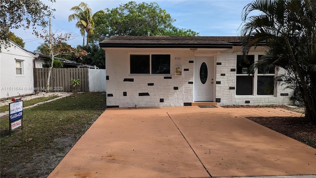 view of front of house featuring crawl space and fence