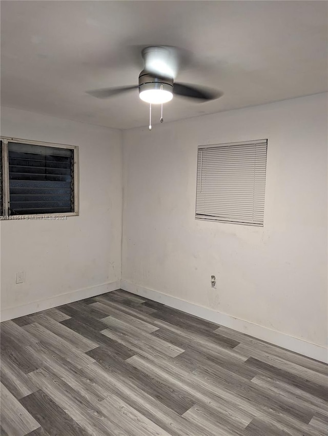 spare room featuring wood-type flooring and ceiling fan