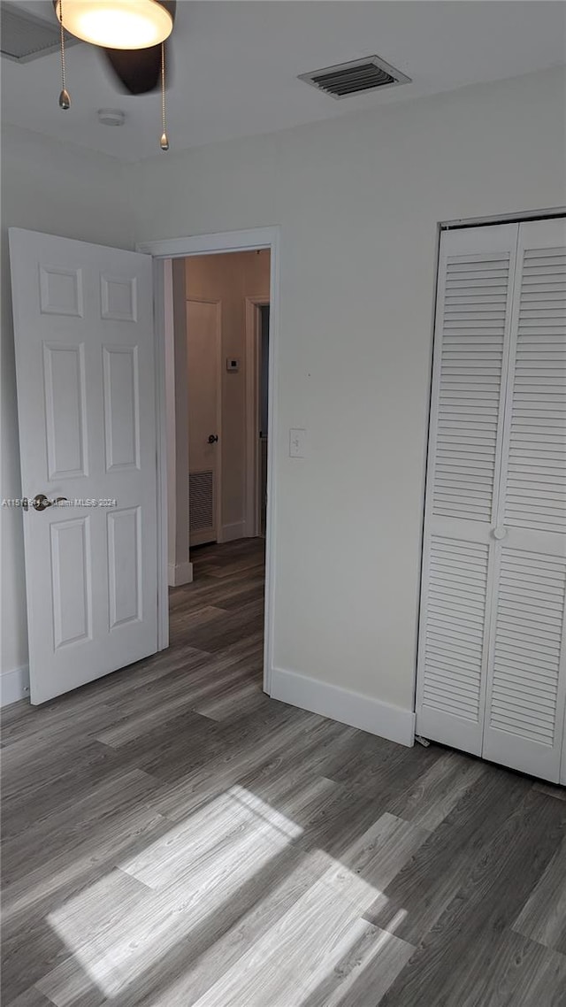 unfurnished bedroom featuring hardwood / wood-style floors and a closet