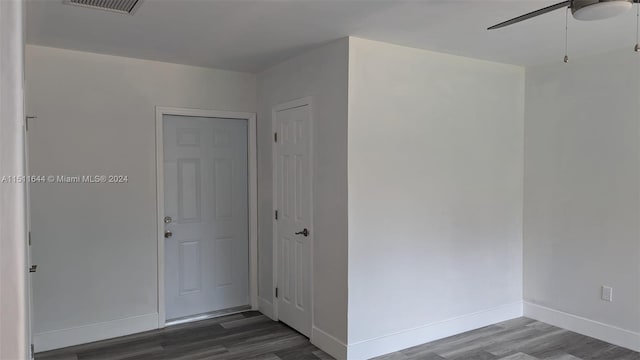 interior space with ceiling fan and dark wood-type flooring