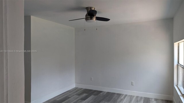 spare room with hardwood / wood-style flooring and ceiling fan