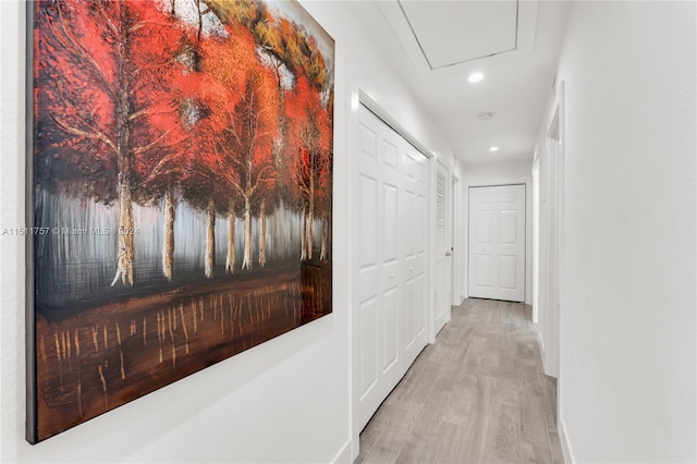 hallway featuring baseboards, wood finished floors, and recessed lighting