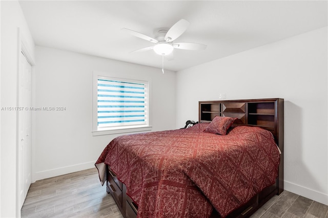 bedroom with ceiling fan, baseboards, and wood finished floors