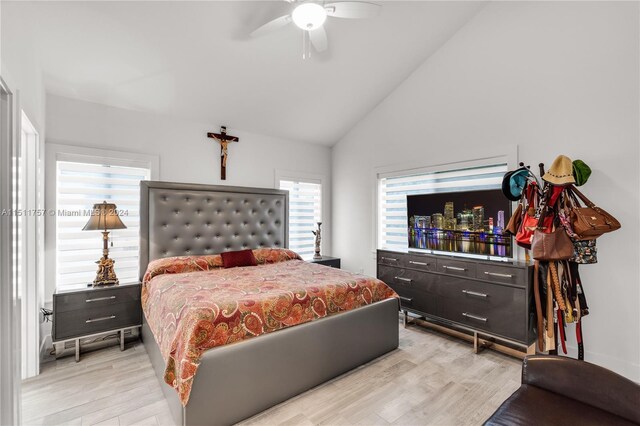 bedroom featuring ceiling fan, light wood-type flooring, and high vaulted ceiling