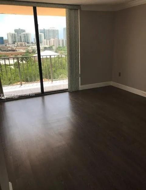 unfurnished room with dark hardwood / wood-style floors