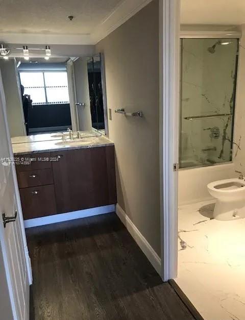 full bathroom featuring toilet, vanity, tub / shower combination, and wood-type flooring