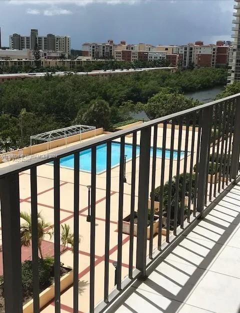 balcony featuring a community pool