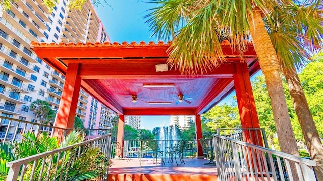 wooden deck featuring ceiling fan