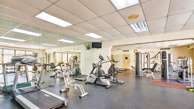 exercise room with a paneled ceiling