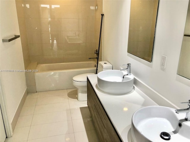 full bathroom with tiled shower / bath, toilet, double vanity, and tile floors