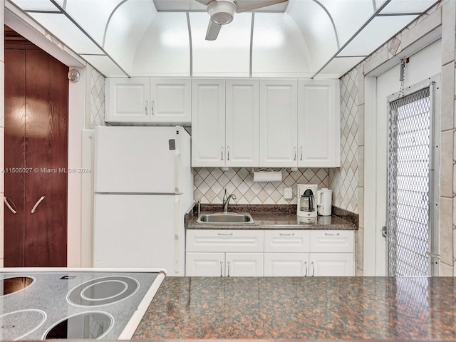 kitchen with white cabinets, sink, ceiling fan, and white fridge