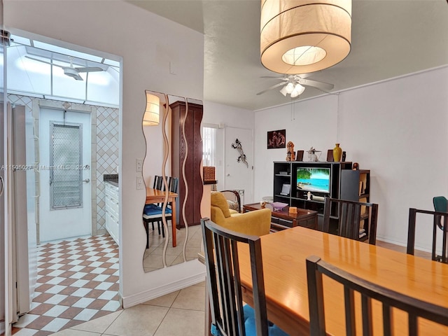 dining space featuring ceiling fan and light tile flooring