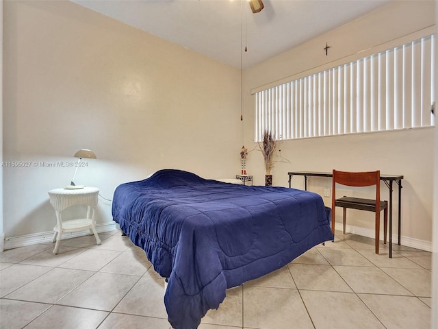 bedroom with ceiling fan and light tile floors