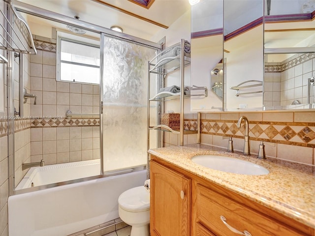 full bathroom with vanity, backsplash, bath / shower combo with glass door, tile flooring, and toilet