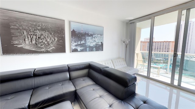 living room featuring expansive windows and a healthy amount of sunlight