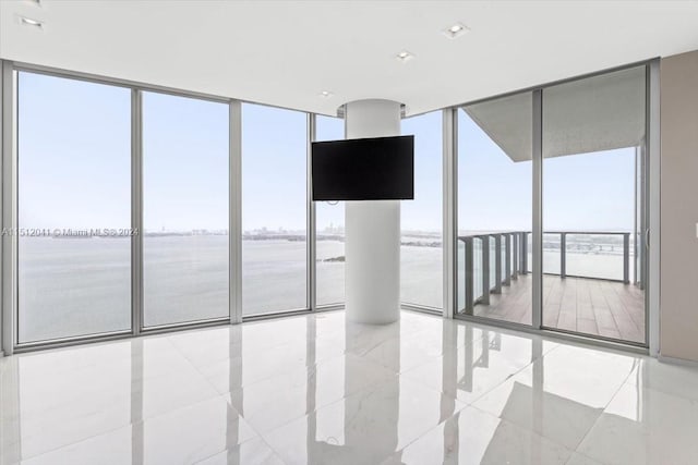 tiled spare room with expansive windows