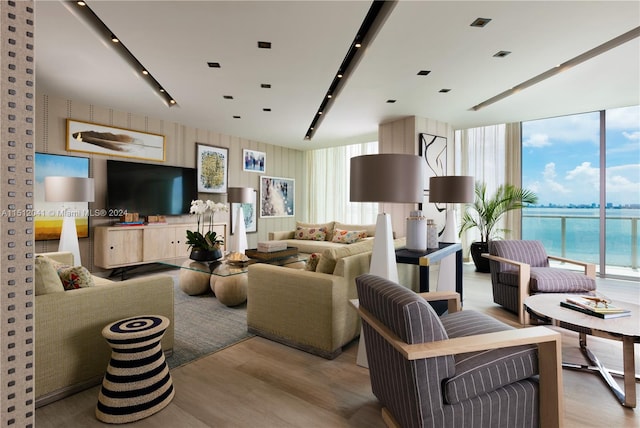 living room with light hardwood / wood-style floors, expansive windows, and a water view