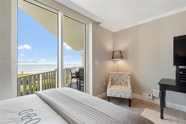 bedroom featuring access to exterior, crown molding, a water view, and wood-type flooring