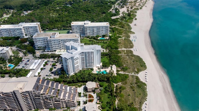 birds eye view of property featuring a water view and a view of the beach