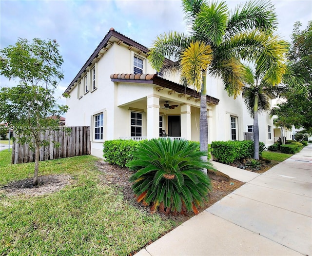 mediterranean / spanish house with a front lawn