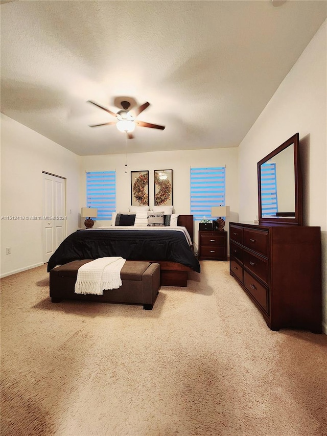 carpeted bedroom with a closet and ceiling fan