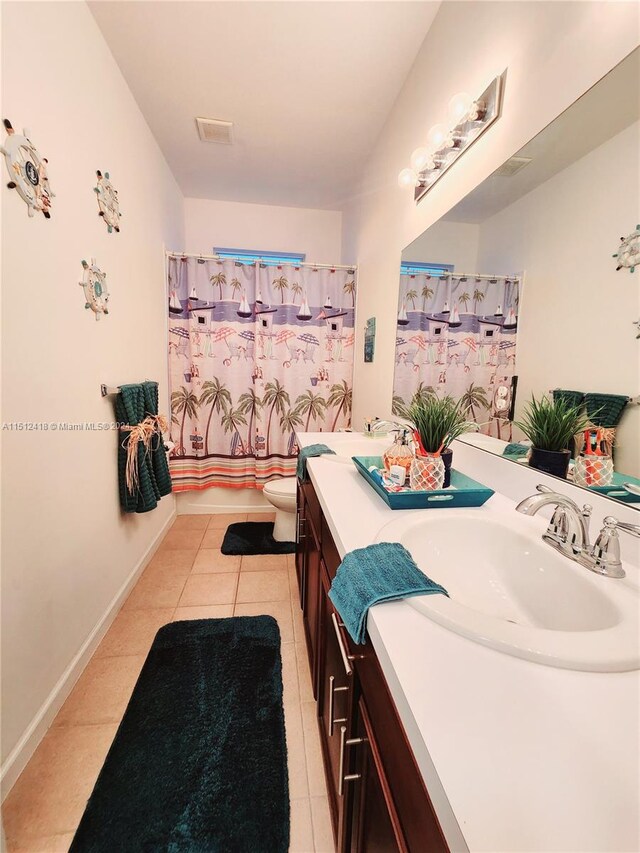 bathroom featuring vanity, tile patterned flooring, and toilet