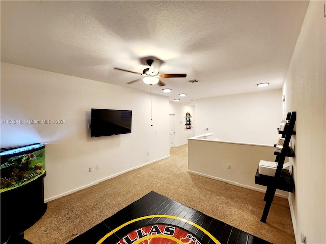 carpeted living room with a textured ceiling and ceiling fan