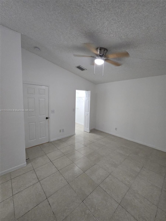 spare room with ceiling fan and vaulted ceiling