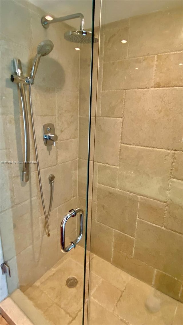 bathroom with a shower with shower door